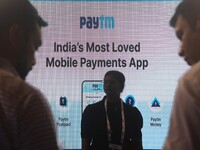 People stand in front of a Paytm advertisement during the Global Fintech Fest in Mumbai, India, 20 September, 2022. (