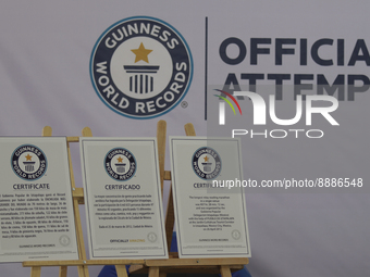 Guinness World Record certificates for a massive boxing class, reading and the world's largest enchilada are displayed during a press confer...