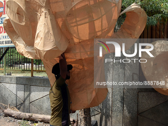 A worker picks up an effigy of Ravana - mythical demon king of Lanka in Hindu mythology, which is to be burned at Dussehra festival in New D...