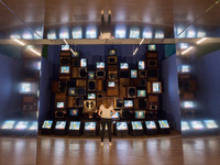 LONDON, UNITED KINGDOM - SEPTEMBER 21, 2022: A staff member looks at Mirage Stage by Nam June Paik, 1986, a video sculpture featuring 33 TV...