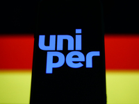 Uniper logo displayed on a phone screen and German flag displayed on a screen in the background are seen in this illustration photo taken in...