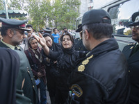 April 23, 2007 file photo shows, An Iranian woman gestures while talking to two morality policemen in Tehran. Thousands of Iranians protest...