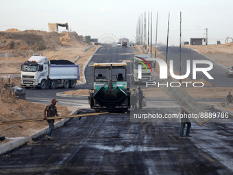 Palestinian workers lay asphalt as a Al-Rashid street is paved in North Gaza Strip, on September 21, 2022.
 (
