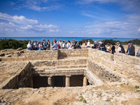 Tourists visit the Archeologic site of the Tombs of the Kings in Paphos, Cyprus on March 5, 2022. (