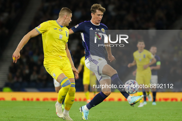 Jack Hendry of Scotland controls the ball under pressure from Artem Dovbyk of Ukraine during the UEFA Nations League match between Scotland...
