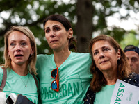 Tears stream down the faces of Allie Burby, Ivy Domont, and Cathy Lieberman (left to right), survivors of the Highland Park shooting, as the...