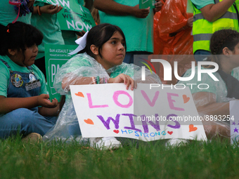 A child holds a sign reading 'love wins, HP strong' during a rally near the U.S. Capitol in Washington, D.C. on September 22, 2022 to urge t...