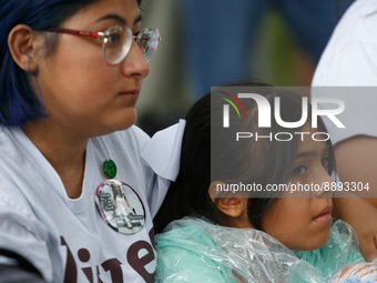 A woman and child listen during a rally near the U.S. Capitol in Washington, D.C. on September 22, 2022 to urge the Senate to pass a federal...