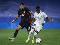 Vinicius Junior left winger of Real Madrid and Brazil and Dominik Szoboszlai attacking midfield of RB Leipzig and Hungary compete for the ba...