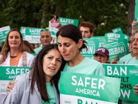 Ivy Domont (right) hugs Emily Liberman at the conclusion of a rally demanding the Senate pass an assault weapons ban.  Both are survivors of...