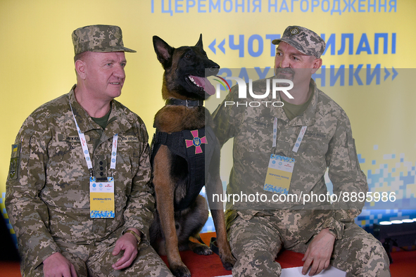 KYIV, UKRAINE - SEPTEMBER 22, 2022 -  Cynologists of the Armed Forces of Ukraine Petro Bruzhyna and Leonid Levchenko are seen with their ser...