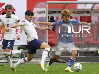Ritsu Doan right winger of Japan and SC Freiburg and Aaron Long centre-back of USA and New York Red Bulls compete for the ball during the in...