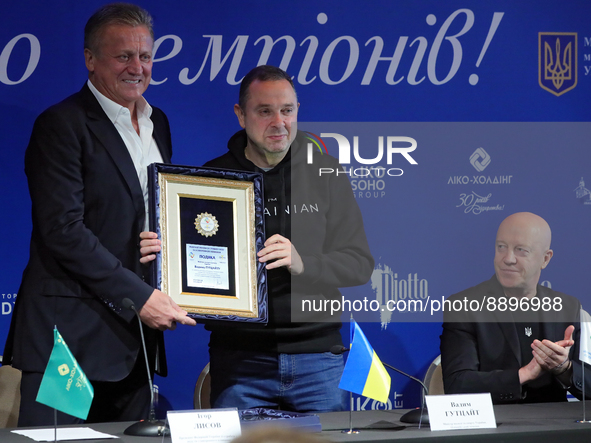 KYIV, UKRAINE - SEPTEMBER 21, 2022 - President of the Ukrainian Diving and Artistic Swimming Federation Ihor Lysov (L) hands over a diploma...