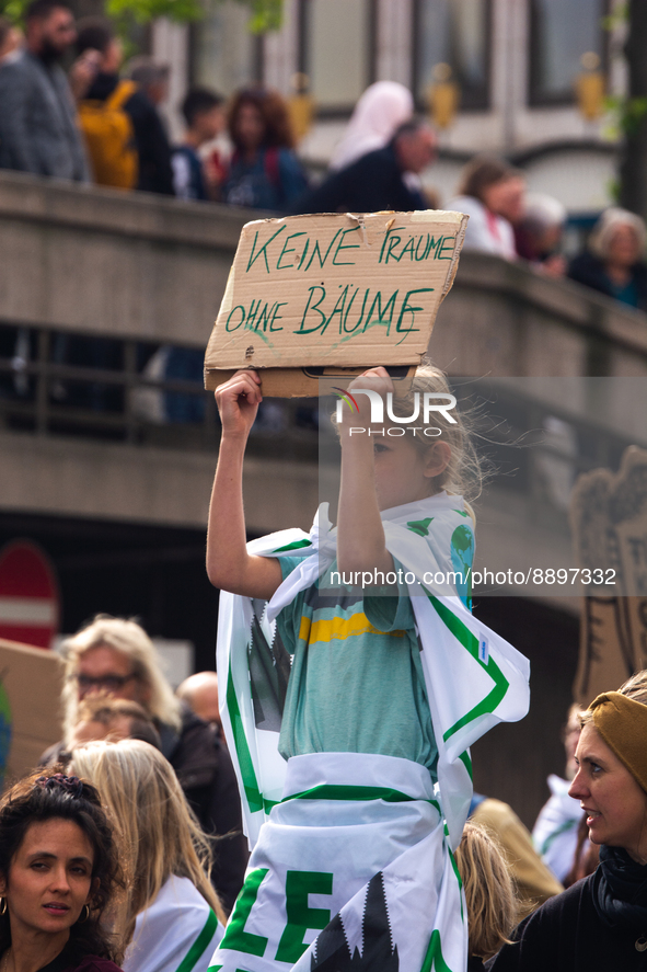a young protester holds a sign of 