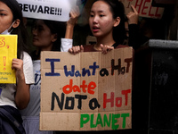An activist holds a placard as she participates in a march during a 