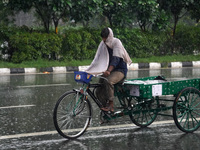 A man rides his cycle rickshaw during a spell of rain in New Delhi, India on September 22, 2022.  (