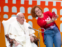 A believer, takes the stage for a selfie with Pope Francis (Jorge Mario Bergolgio) at the end of the meeting in Assisi, organised by Economy...