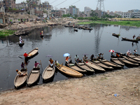 Boats are seen carrying passengers to cross the polluted buriganga river in Dhaka, Bangladesh, on September 25, 2022. World Rivers Day is ob...