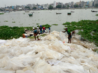 Workers dries reject plastic bag on the bank of Buriganga River in Dhaka, Bangladesh, on September 25, 2022. World Rivers Day is observed on...