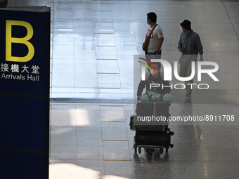 Travelers arriving at Hong Kong International Airport on September 26, 2022 in Hong Kong, China. The Hong Kong Government announced that it...