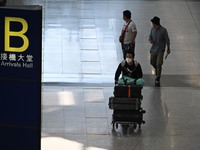 Travelers arriving at Hong Kong International Airport on September 26, 2022 in Hong Kong, China. The Hong Kong Government announced that it...