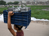 A children carries tiffin carrier at a low income area in Dhaka, Bangladesh on September 26, 2022. (