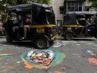 People pass by the potholes painted by a citizens' group in Mumbai, India, 26 September, 2022. Members of the Watchdog Foundation said they...
