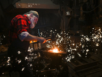 Krzysztof Panas, a local master blacksmith from the vicinity of Lancut, at work during a demonstration in a traditional blacksmith's worksho...
