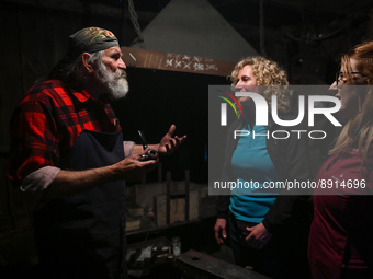 Krzysztof Panas, a local master blacksmith from the vicinity of Lancut, explains to visitors the secrets of his profession at the end of a d...