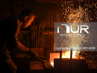 Marcin Kosciak, a local artist blacksmith from the vicinity of Lancut, is seen at work during a demonstration in a traditional blacksmith's...