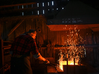 Krzysztof Panas, a local master blacksmith from the vicinity of Lancut, at work during a demonstration in a traditional blacksmith's worksho...