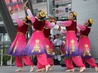 Chinese dancers dressed in traditional outfits perform a cultural dance during the Community Crime Awareness Day in Mississauga, Ontario, Ca...