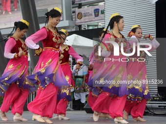 Chinese dancers dressed in traditional outfits perform a cultural dance during the Community Crime Awareness Day in Mississauga, Ontario, Ca...