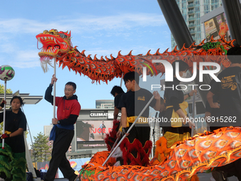 Chinese dancers perform a traditional Dragon Dance during the Community Crime Awareness Day in Mississauga, Ontario, Canada, on September 26...