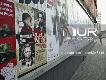 A poster advertising a theatre piece called 'Children's Furnace' is seen next to a poster advertising the anniversary of German aggression a...
