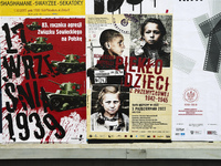 A poster advertising a theatre piece called 'Children's Furnace' is seen next to a poster advertising the anniversary of German aggression a...