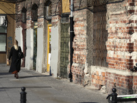 A woman walks past the Prozna 14 building in the last reaming part of the Warsaw Ghetto in Warsaw, Poland on 26 September, 2022. (
