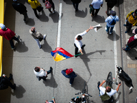 A demonstrator waves a Colombian flag during the first antigovernment protest against left-wing president Gustavo Petro and his initiative o...
