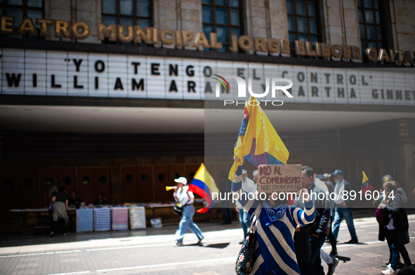 A demonstrator holds a sign that reads 'No To Narcoterrorist Comunism' during the first antigovernment protest against left-wing president G...