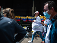A demonstrator holds a sign against several reforms during the first antigovernment protest against left-wing president Gustavo Petro and hi...
