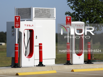 A long row of Tesla superchargers is seen in a Buc-ee's parking lot in Madisonville, Texas on September 26th, 2022.  (