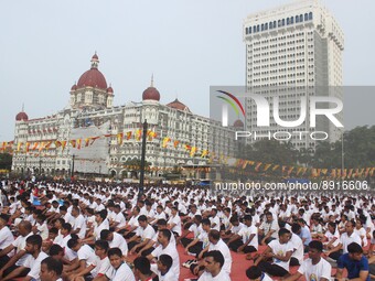 People perform yoga in front of the Taj hotel, during International Yoga Day in Mumbai, India, June 21, 2018. (