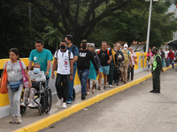 People are seen crossing through the Simon Bolivar International Bridge, during the official reopening ceremony of the border crossing point...