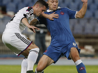 Basel's defender Taulant Xhaka (L) vies for the ball with Belenenses's midfielder Andre Sousa (R)  during the UEFA Europa League  football m...