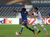 Belenenses's forward Kuca vies with Basel's defender Michael Lang during the UEFA Europa League Group I football match between Os Belenenses...