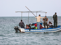 Guard coast agent on a fish boat transferring migrants to another unity to take them to the land. (