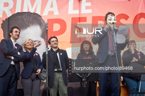 A Guy Fawkes mask red a letter during the presentation of Italy's Tsipras List in Piazza Affari (Milan Stock Exchange) , on April 23, 2014. 