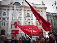 The middle finger sculpure of Maurizio Cattelan coverd of Tsipras red flag during the presentation of Italy's Tsipras List in Piazza Affari...