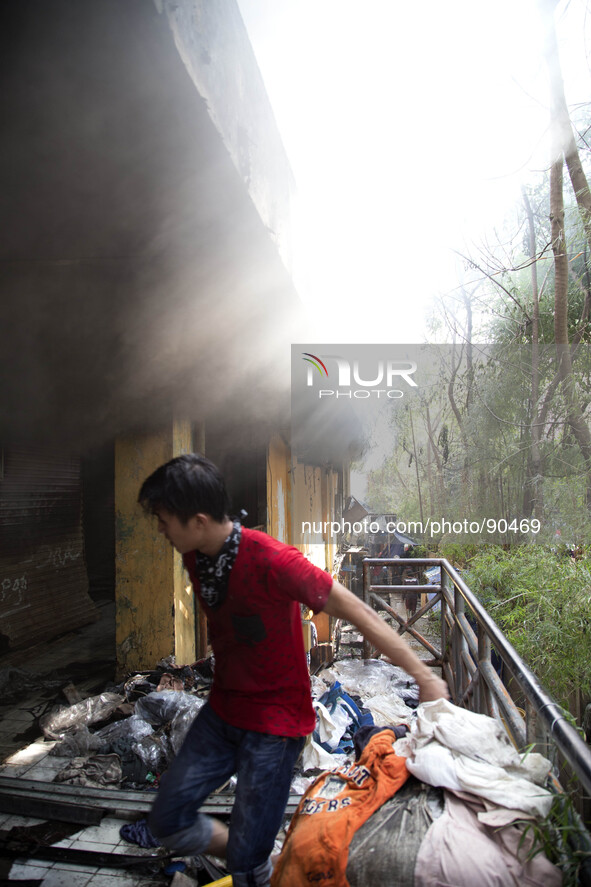Owner of a burn kiosk at Senen Market try to save some items. The Senen Market in Central Jakarta was gutted by a fire on Friday morning. Th...