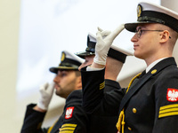 Navy servicemen salute during the celebration of the 100th anniversary of Naval Academy of the Heroes of Westerplatte in Gdynia, Poland on O...